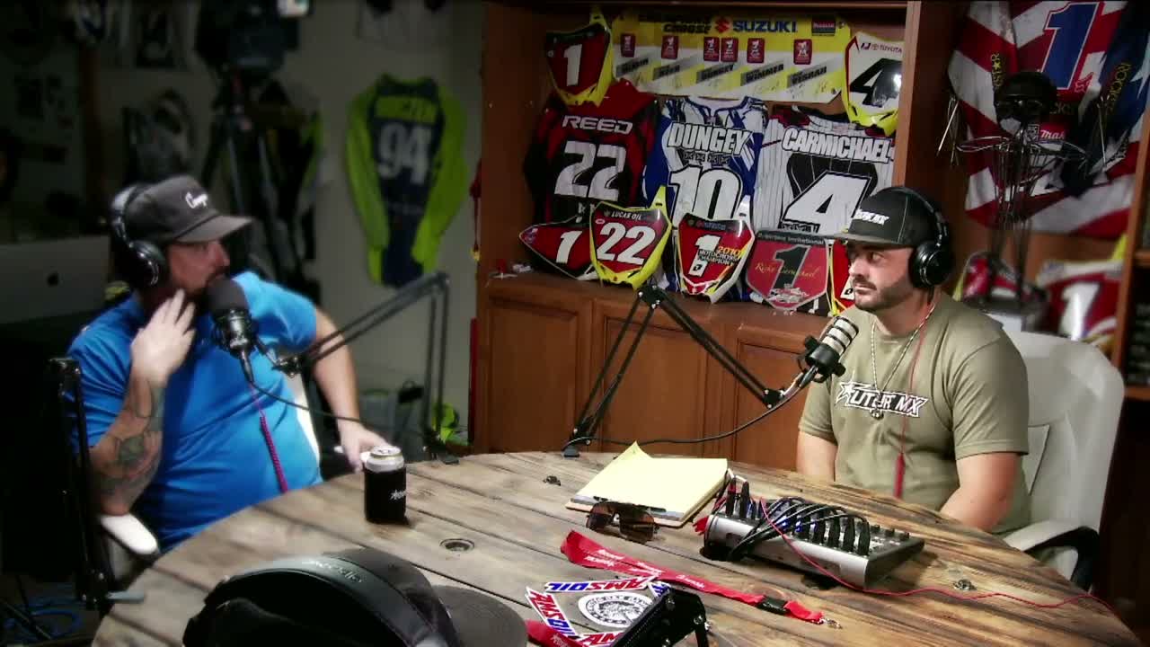 Two guests at the round table in The Legends Room during Episode 43, an audio mixer between them and signed race jerseys behind